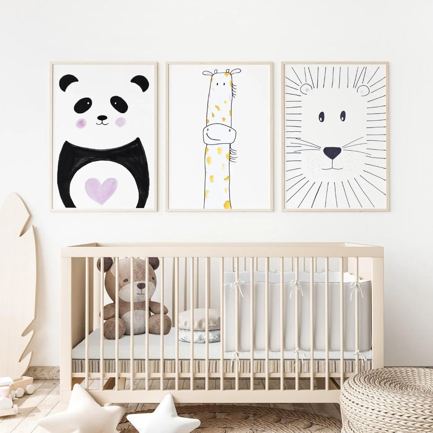 A nursery with animal prints on the wall and a teddy bear in the crib